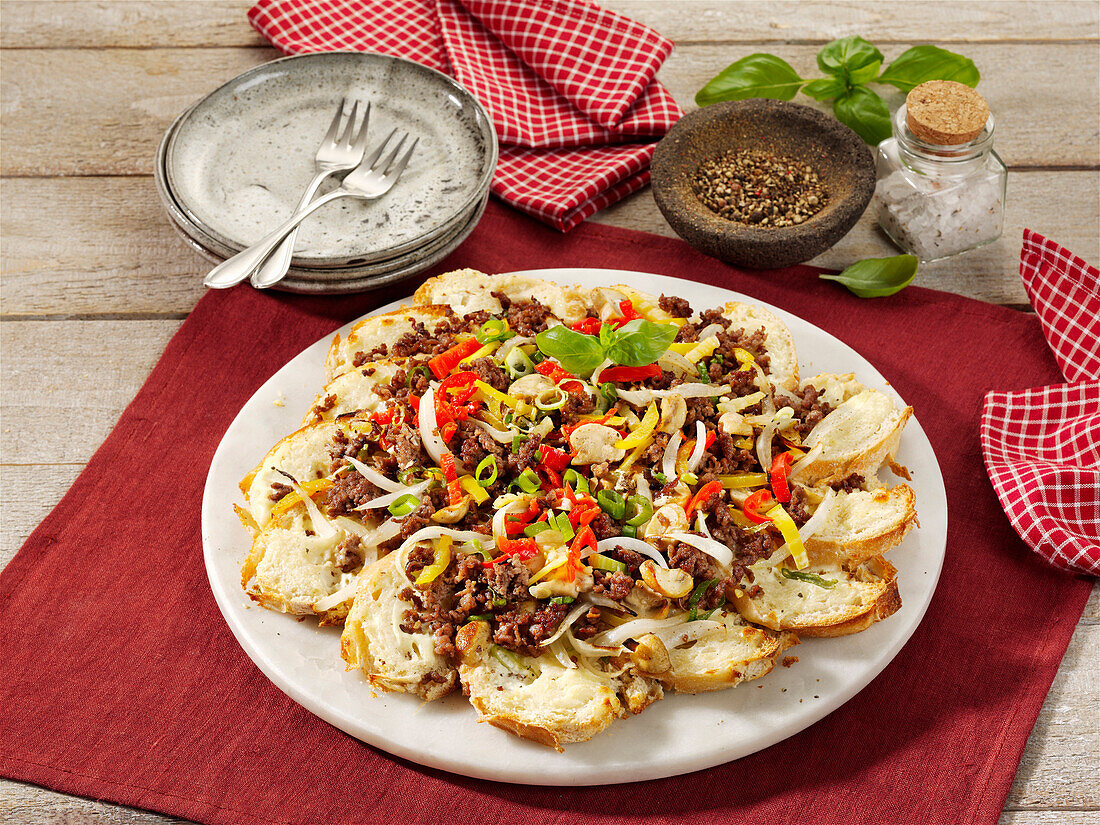 Bread tarte flambée with ground meat, mushrooms and peppers