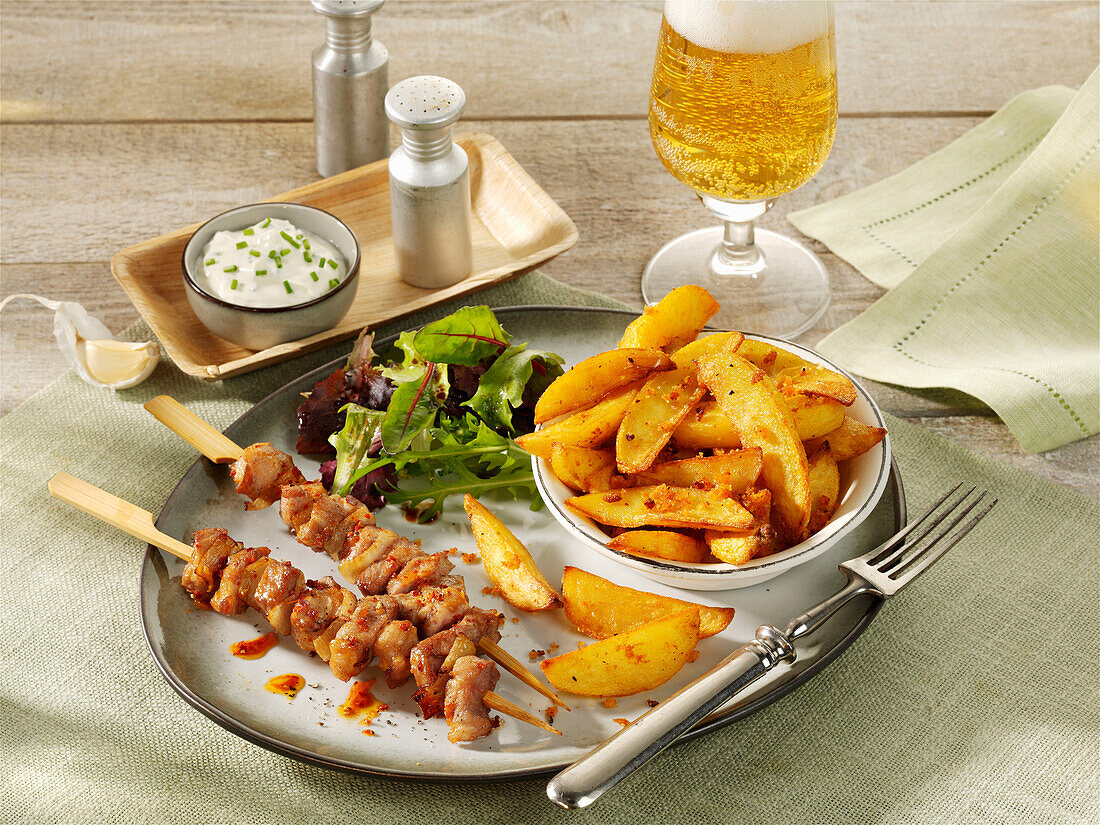 Pork neck skewers with garlic fries