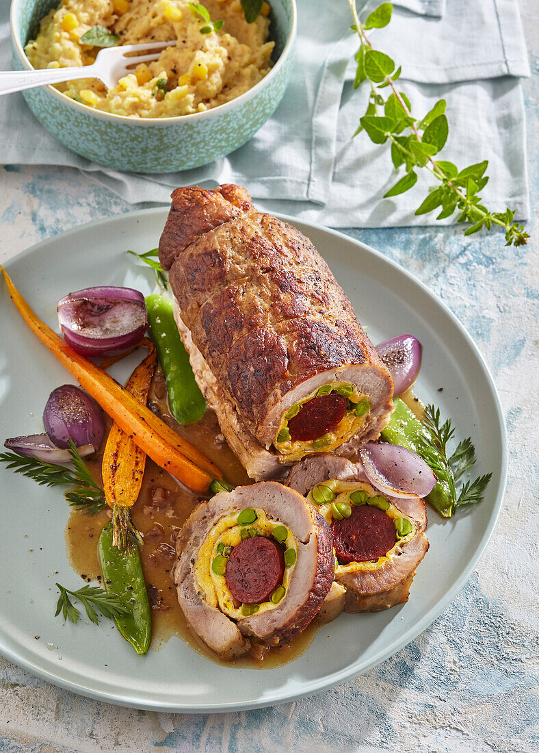 Pork roll roast with sausage stuffing and pea mash