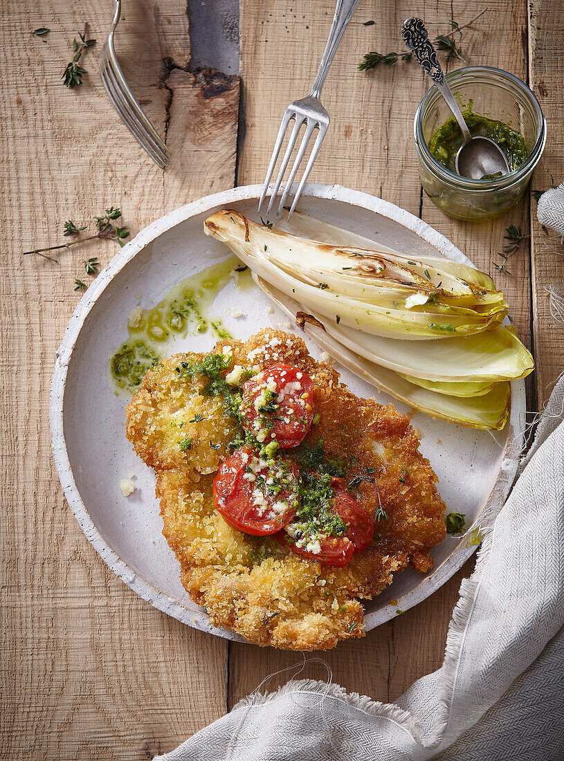 Chicken schnitzel with roasted tomatoes and pesto