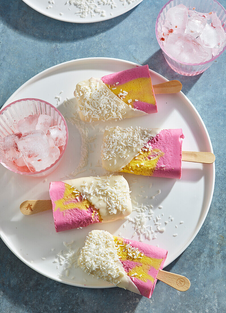 Mango and raspberry ice cream on a stick with white chocolate