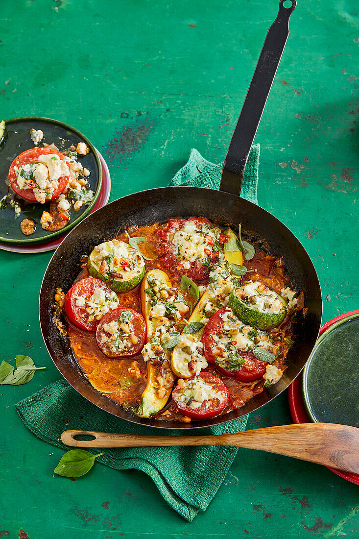 Stewed tomatoes and courgettes with feta and pine nuts