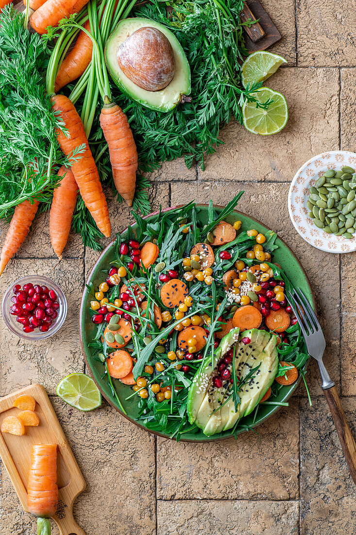 Carrot salad with avocado, pomegranate and black sesam