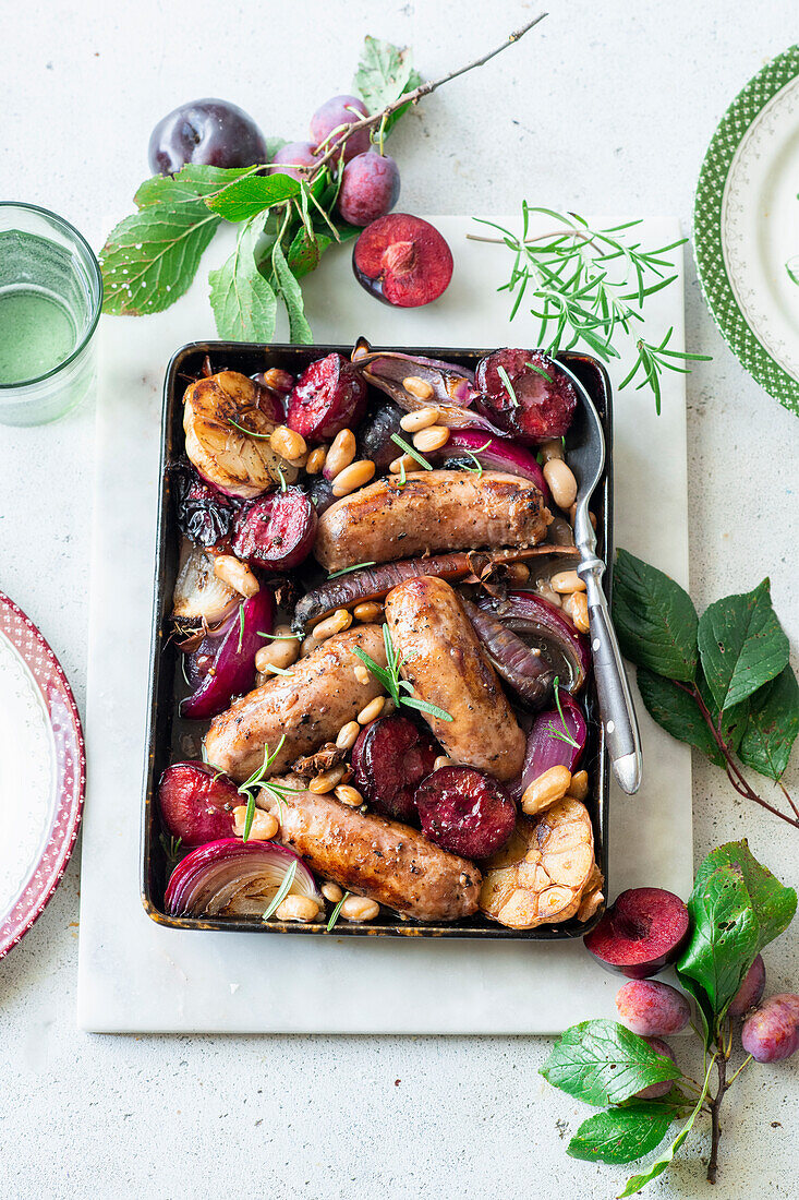 Sausages with sticky plums and garlic