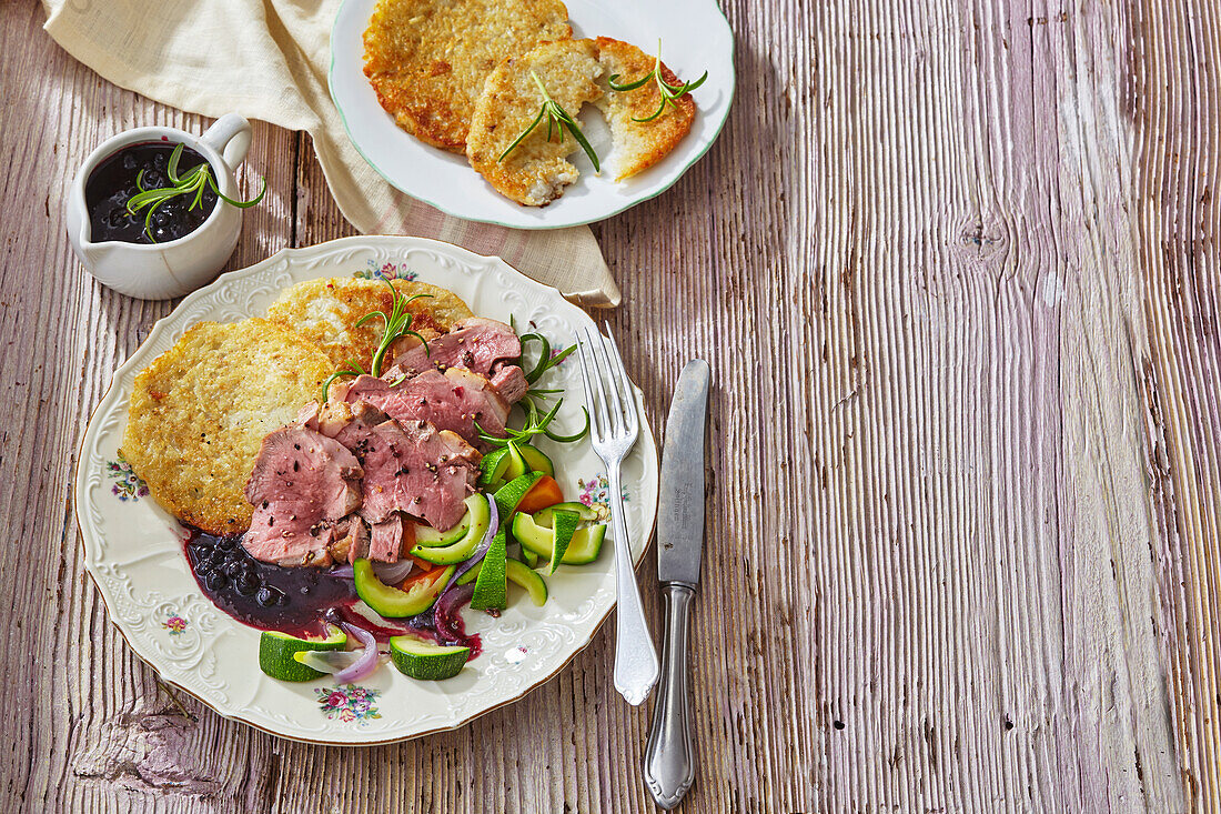 Roast duck breasts with blueberry sauce and hash browns