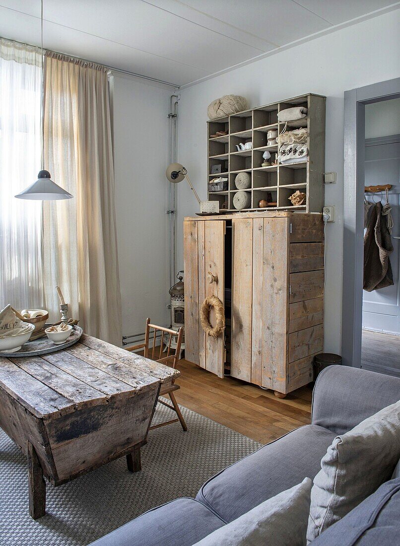 Living room with rustic wooden cupboard and antique coffee table