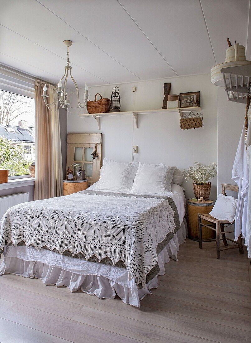 Country-style bedroom with crocheted bedspread and wooden accessories