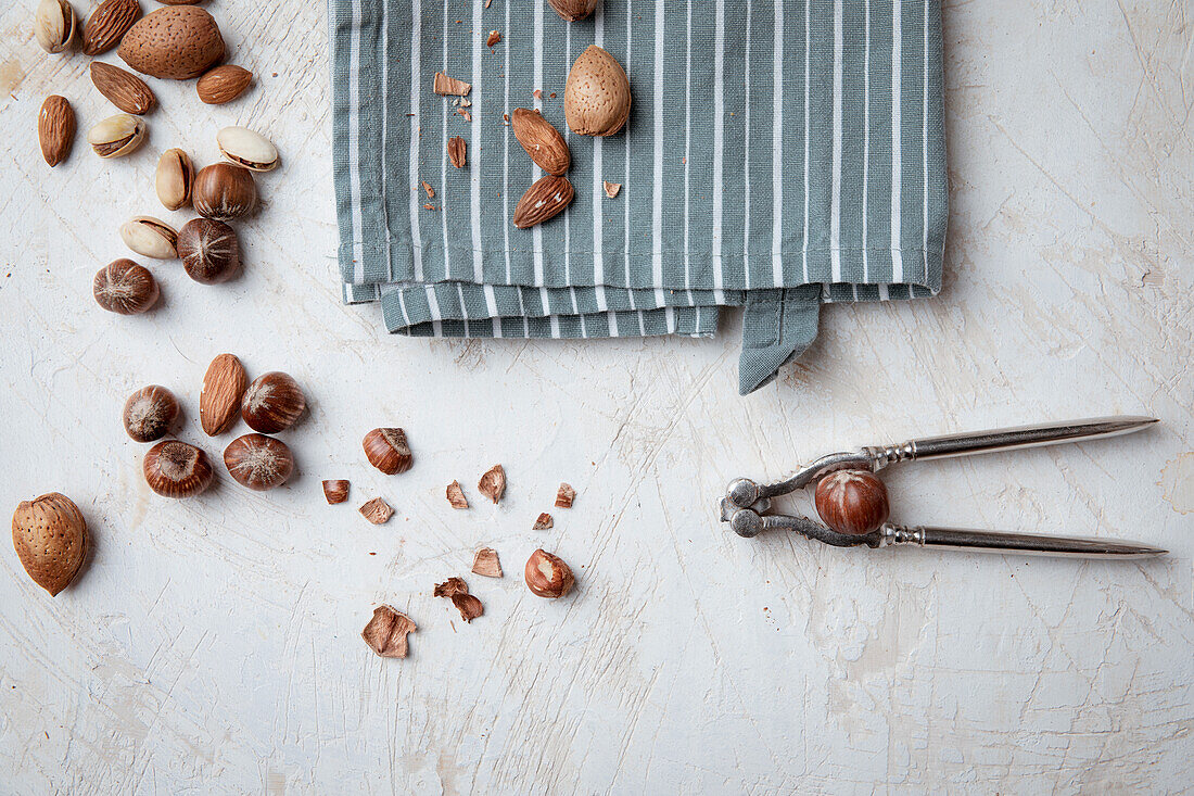 Almonds, hazelnuts and pistachios with shells and nutcracker