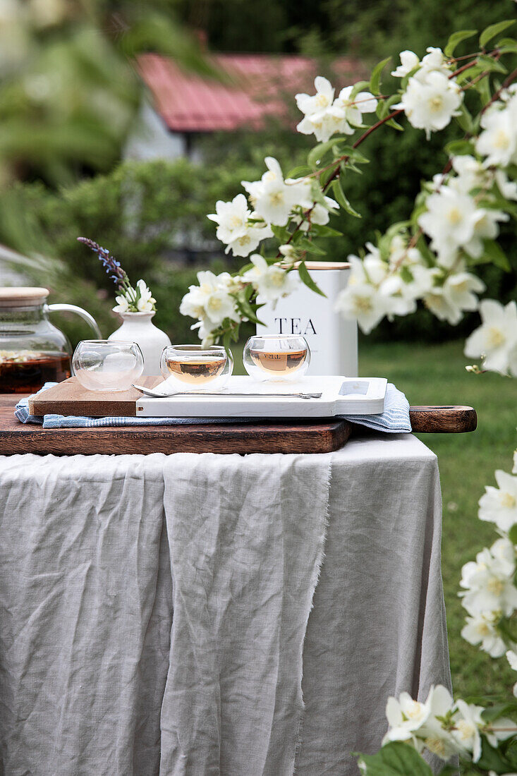 Tea table in the garden next to a jasmine bush