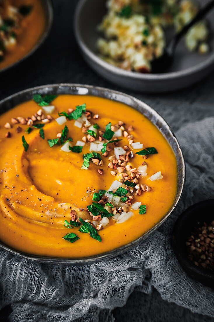 Pumpkin soup with apple and buckwheat topping