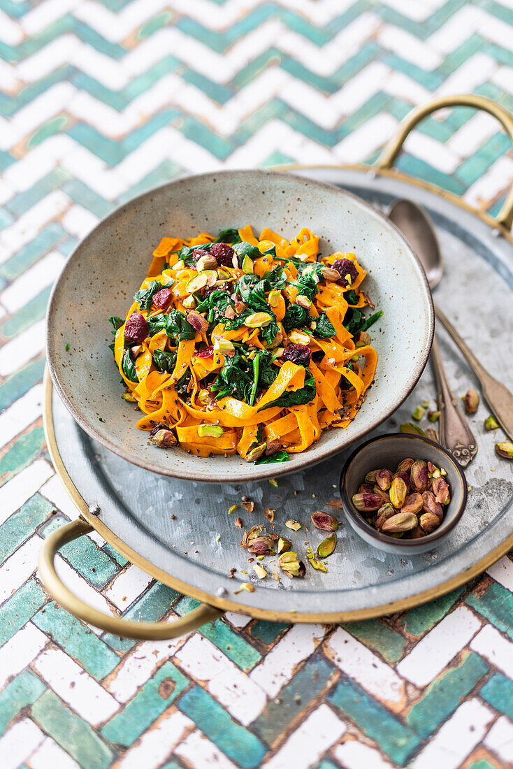 Tagliatelle with carrot powder, spinach, cranberries and pistachios (vegan)