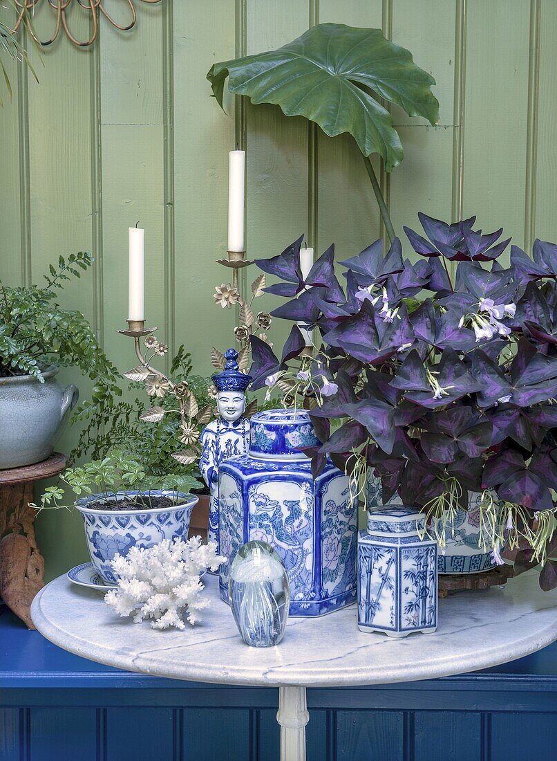 Decorative table with candles, plants and blue and white porcelain