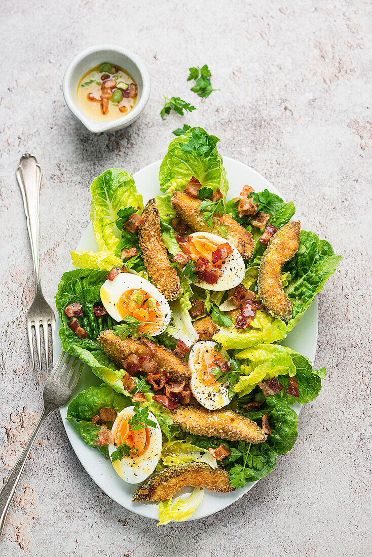 Crispy avocado salad with olive oil and bacon dressing