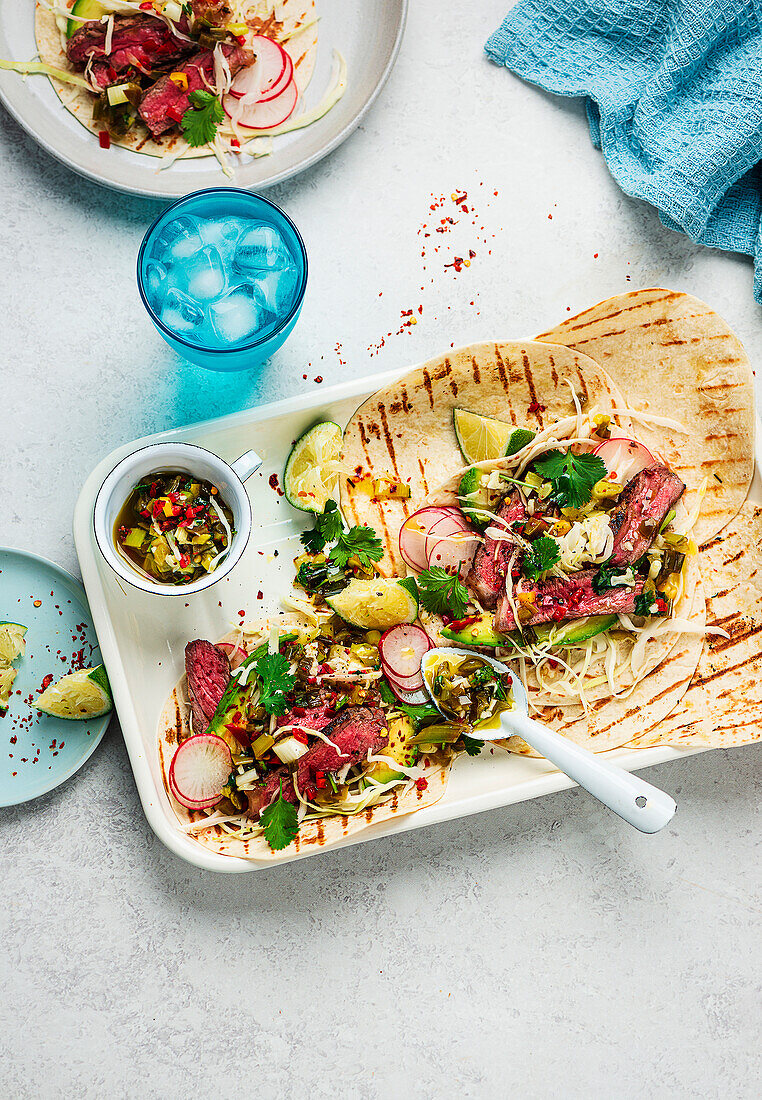 Steak tacos with spring onions and salsa