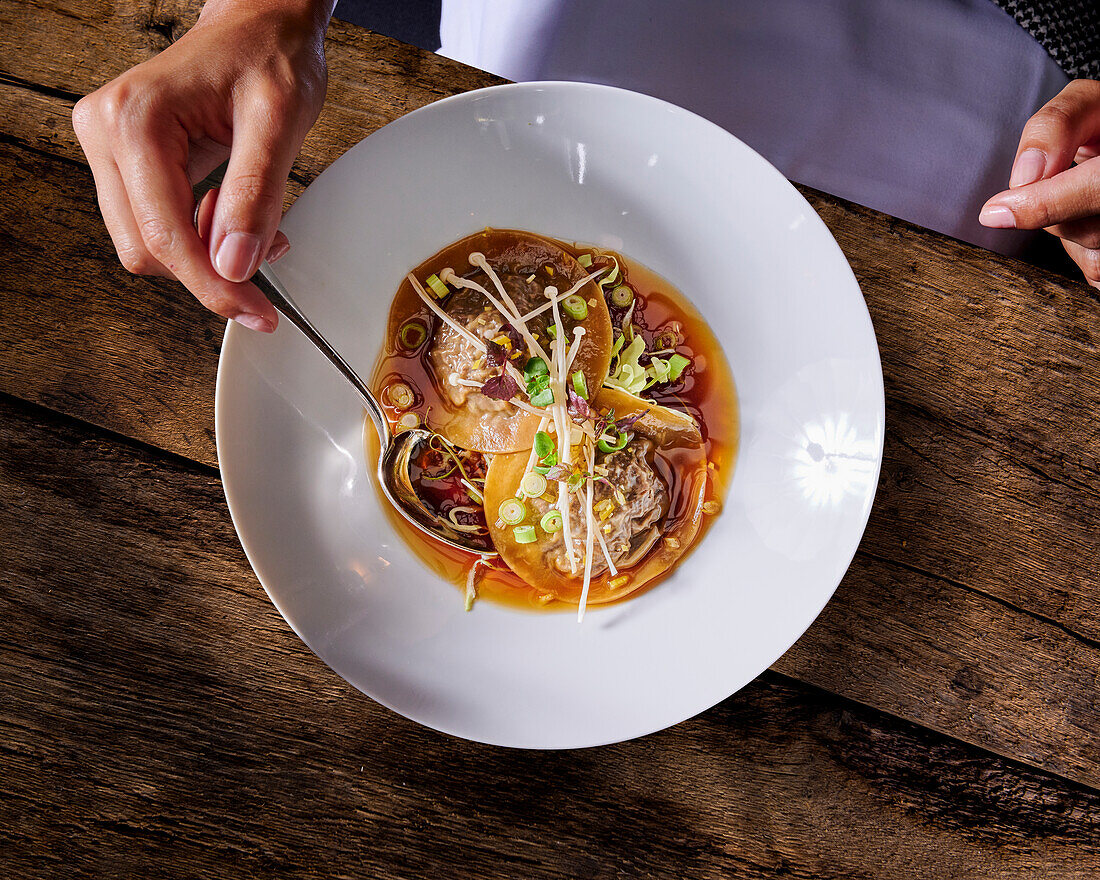 Ravioli with beef cheeks in consommé