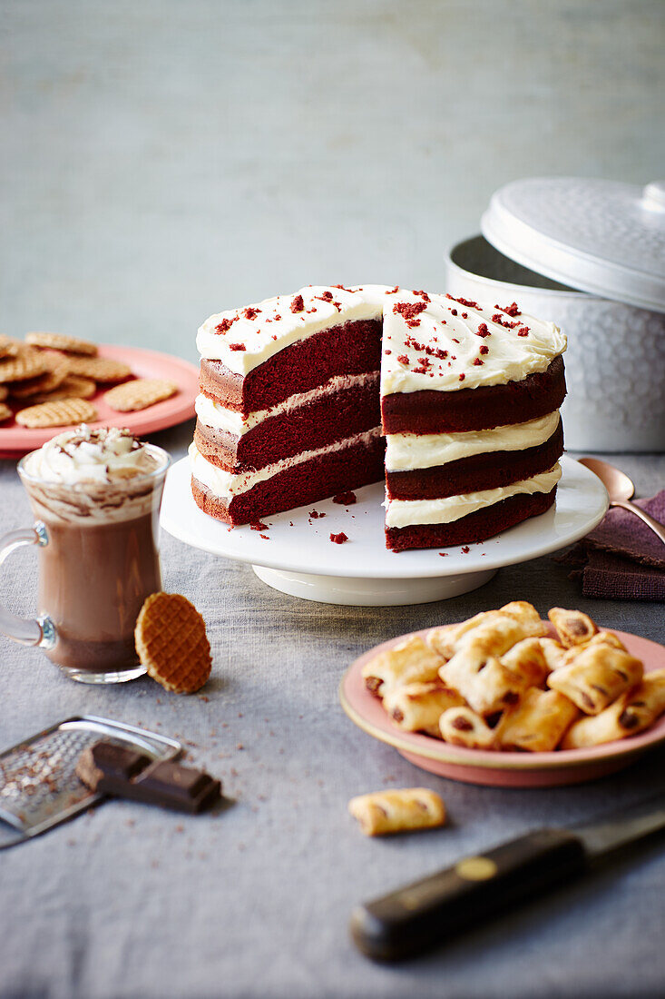Red velvet chocolate cake with cream cheese icing, hot chocolate, mini fig rolls