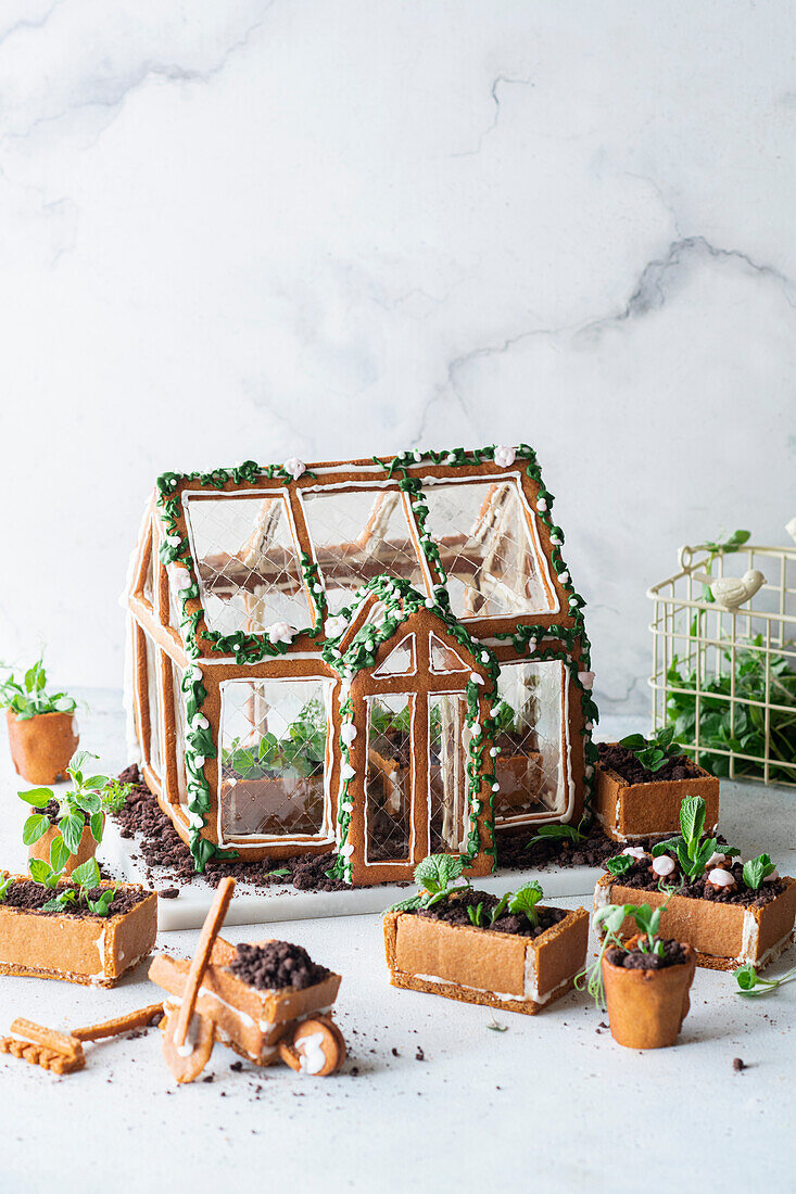 Gingerbread greenhouse with edible plant boxes and chocolate soil