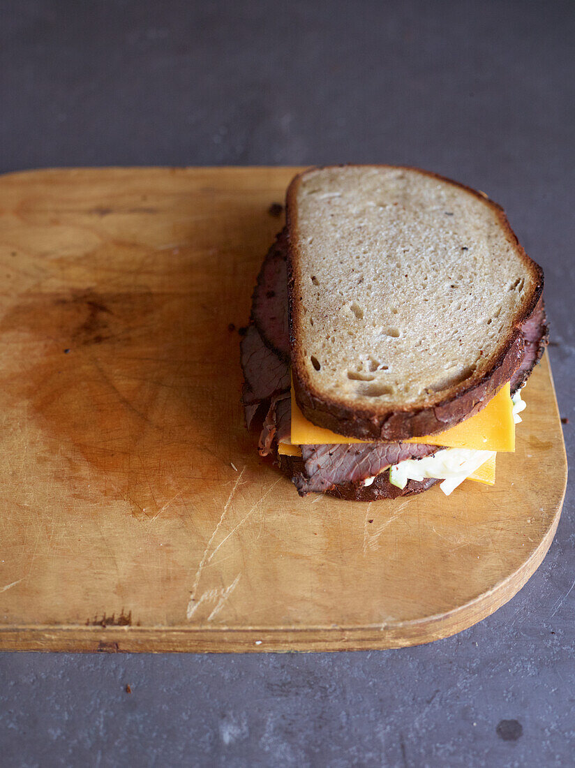 Pastrami sandwich with cheese, mustard and coleslaw