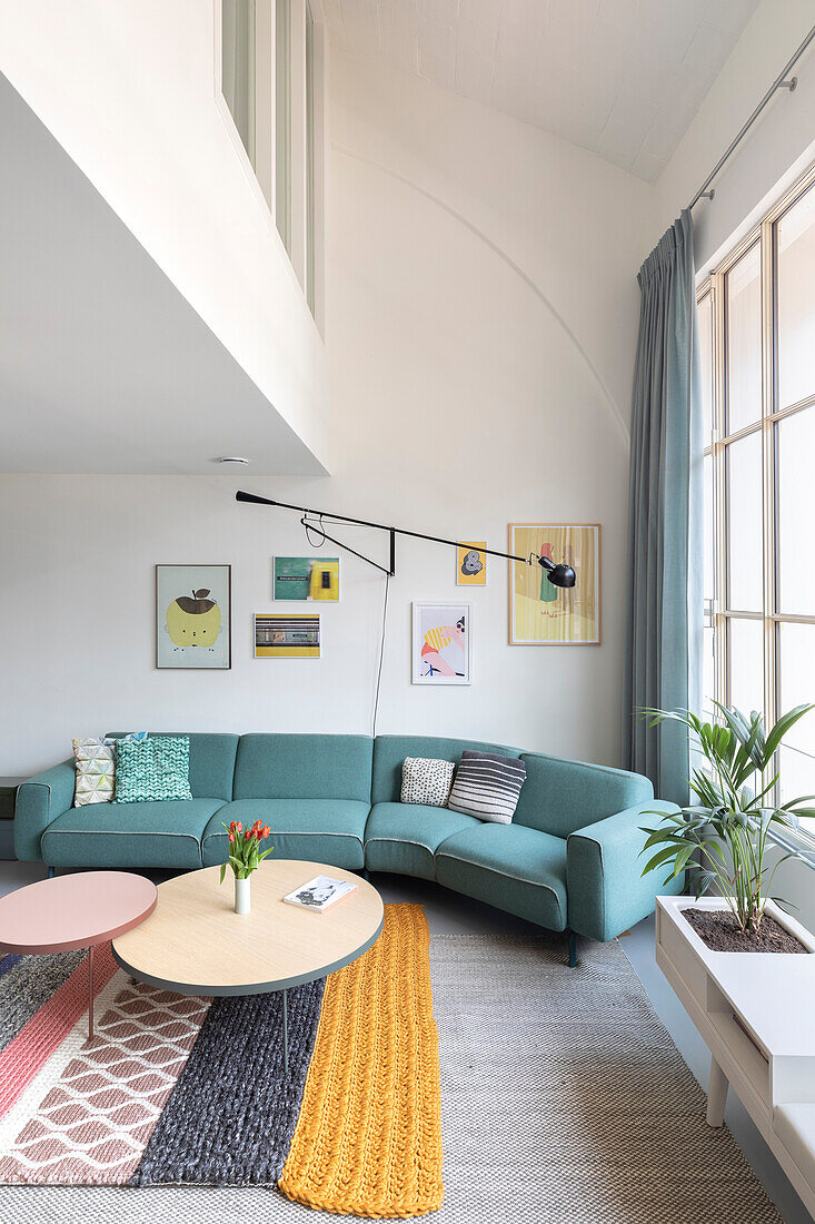 Sitting area with green sofa and colorful wall art in modern living room