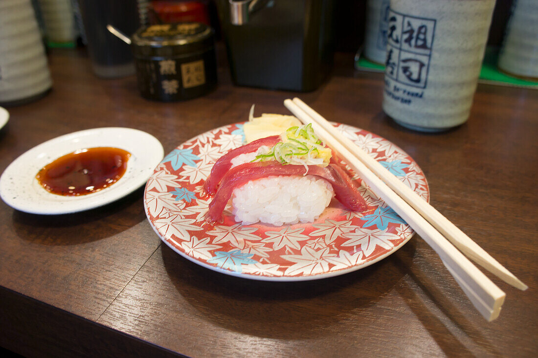 Salmon sushi served on plate with chopstick
