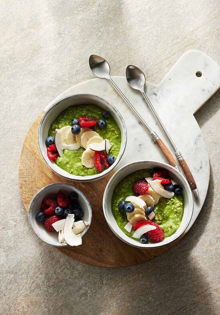 Vegan green overnight oats with spinach, berries and coconut chips