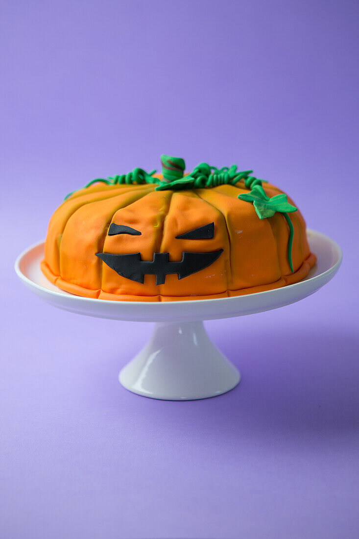 Orange Halloween pumpkin cake with edible decoration