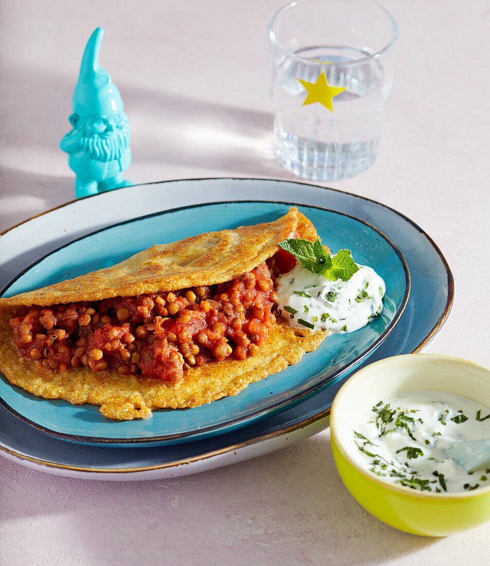 Stuffed crepe with tomato and lentils and yogurt and mint dip