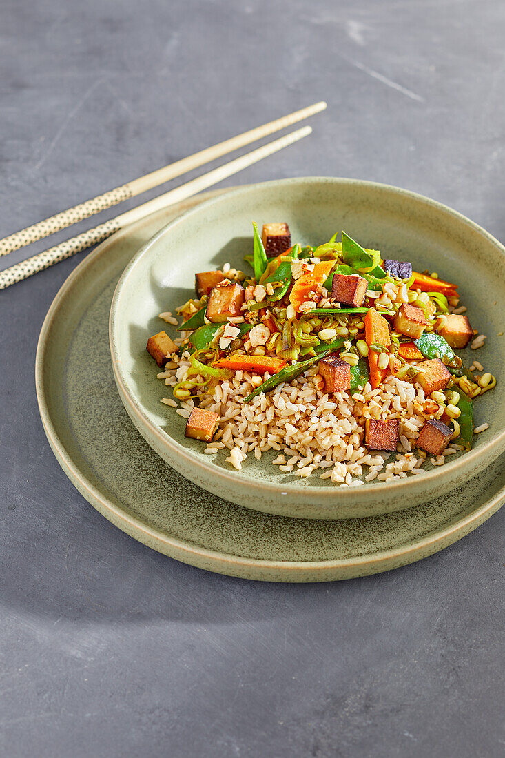 Vegan ginger tofu on Asian vegetables and rice