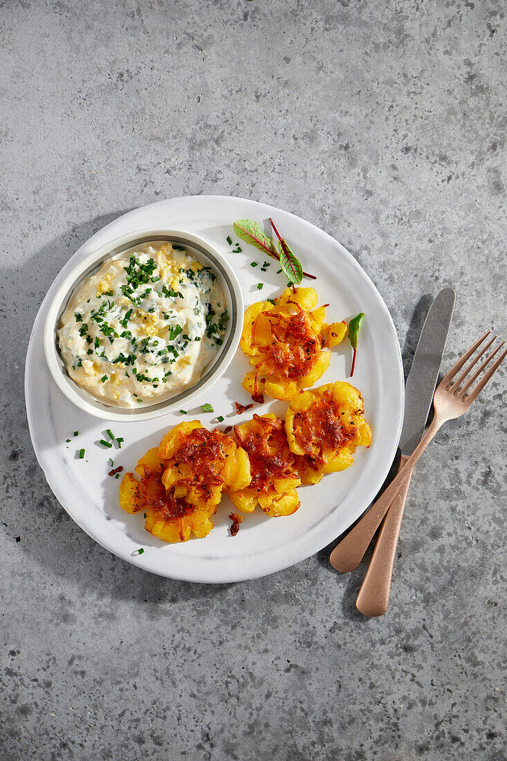 Smashed potatoes with herb and egg sauce