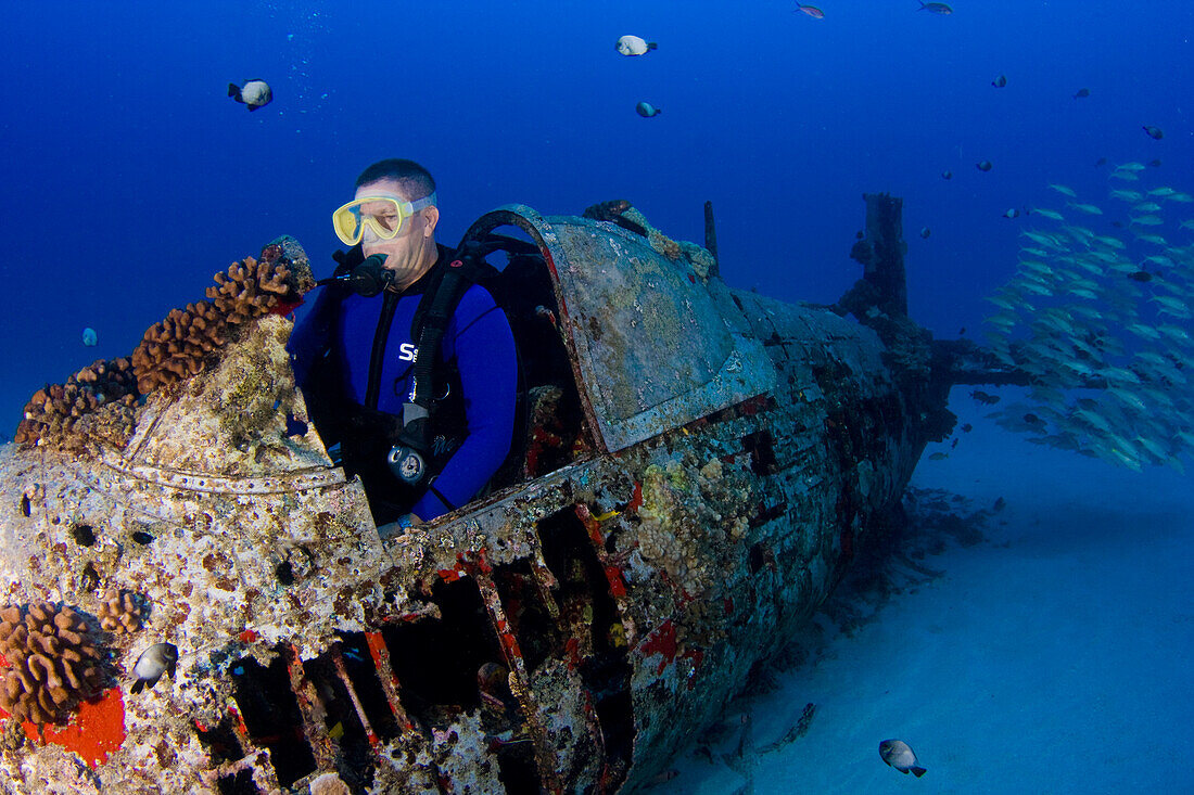 Diver in underwater plane wreck