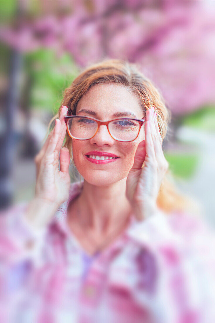Woman adjusting glasses
