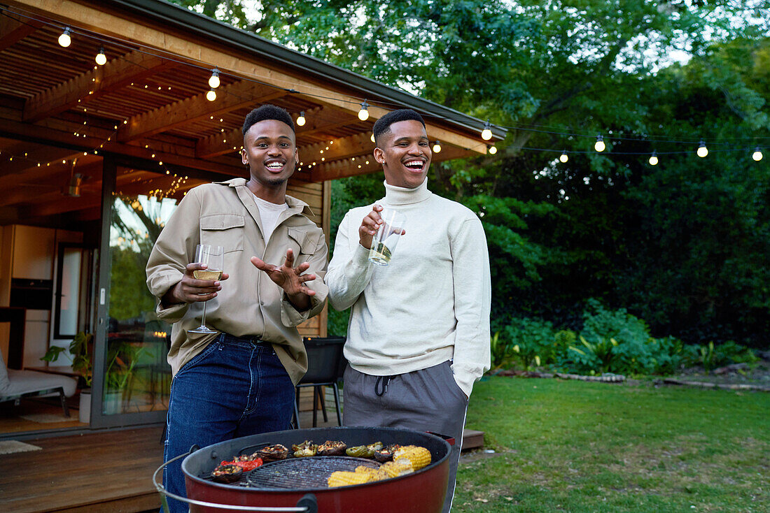 Young gay male couple enjoying barbecue