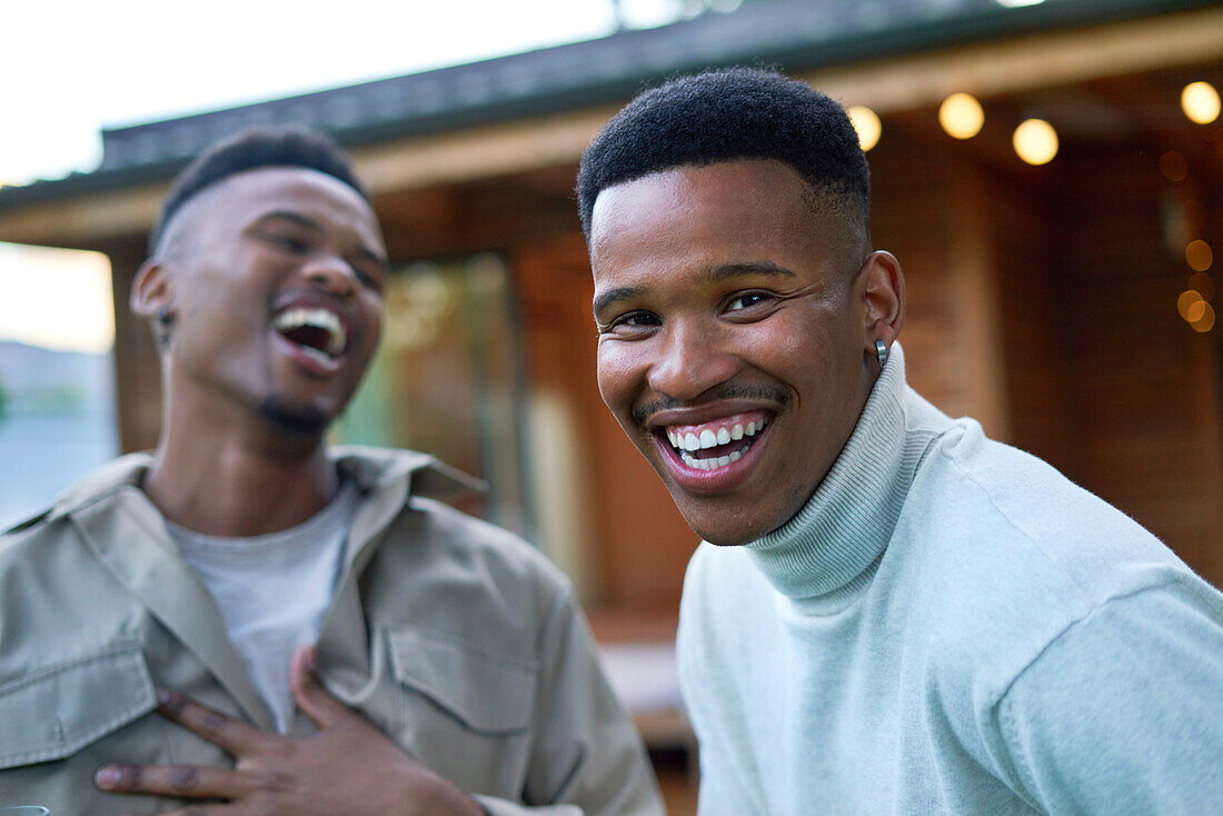 Happy young gay male couple laughing