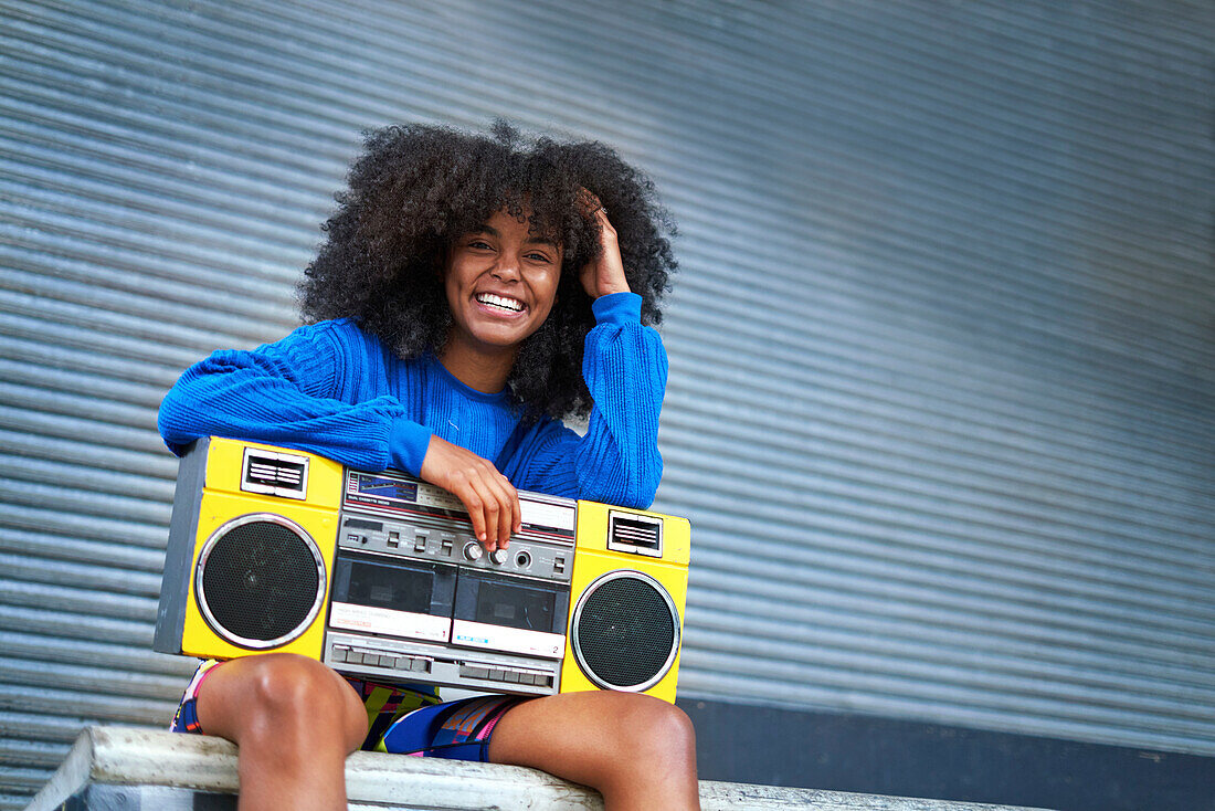Young woman with boom box