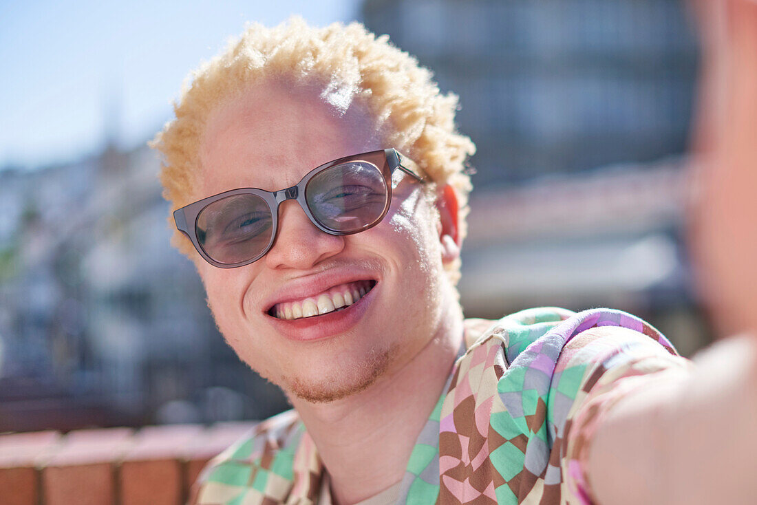 Young albino man smiling