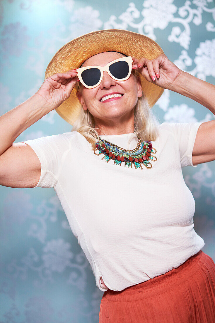 Senior woman in sunglasses and straw hat
