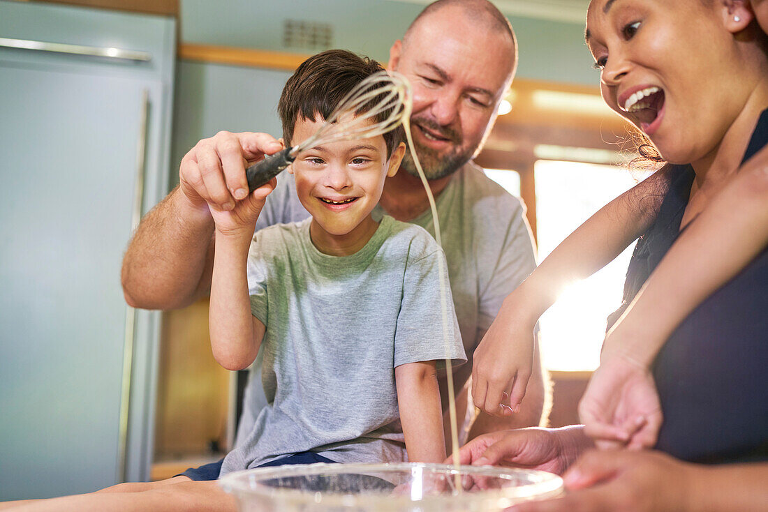 Boy with Down syndrome baking with family at home