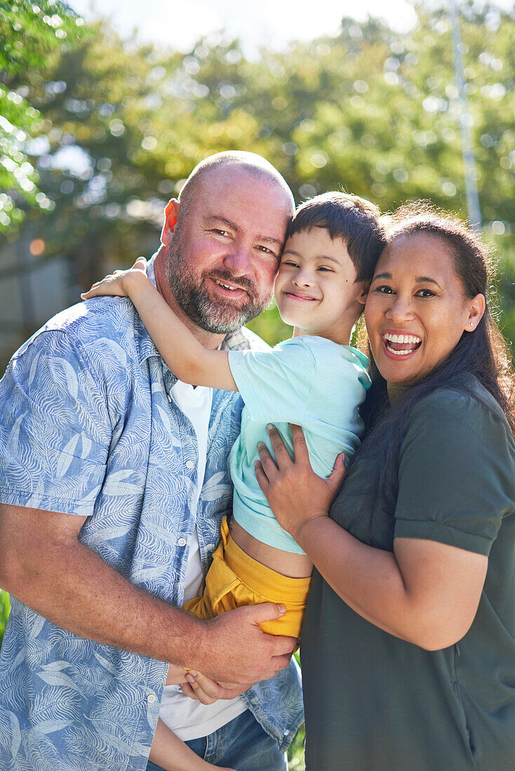 Parents holding son with Down syndrome