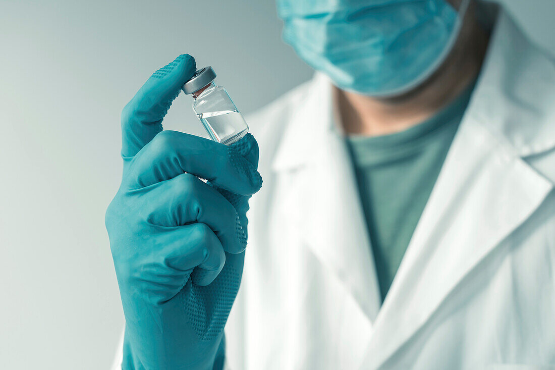 Medical professional holding vaccine vial