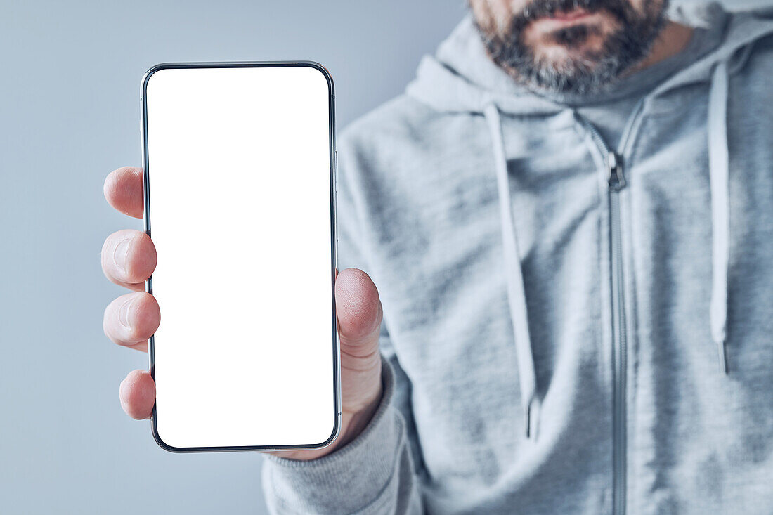 Man holding smartphone with blank screen