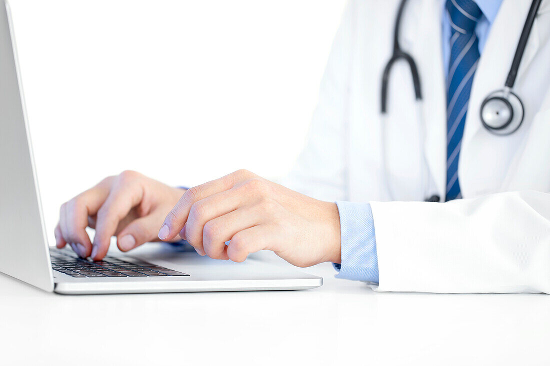 Doctor typing on a laptop