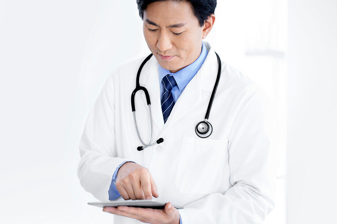 Doctor using tablet computer