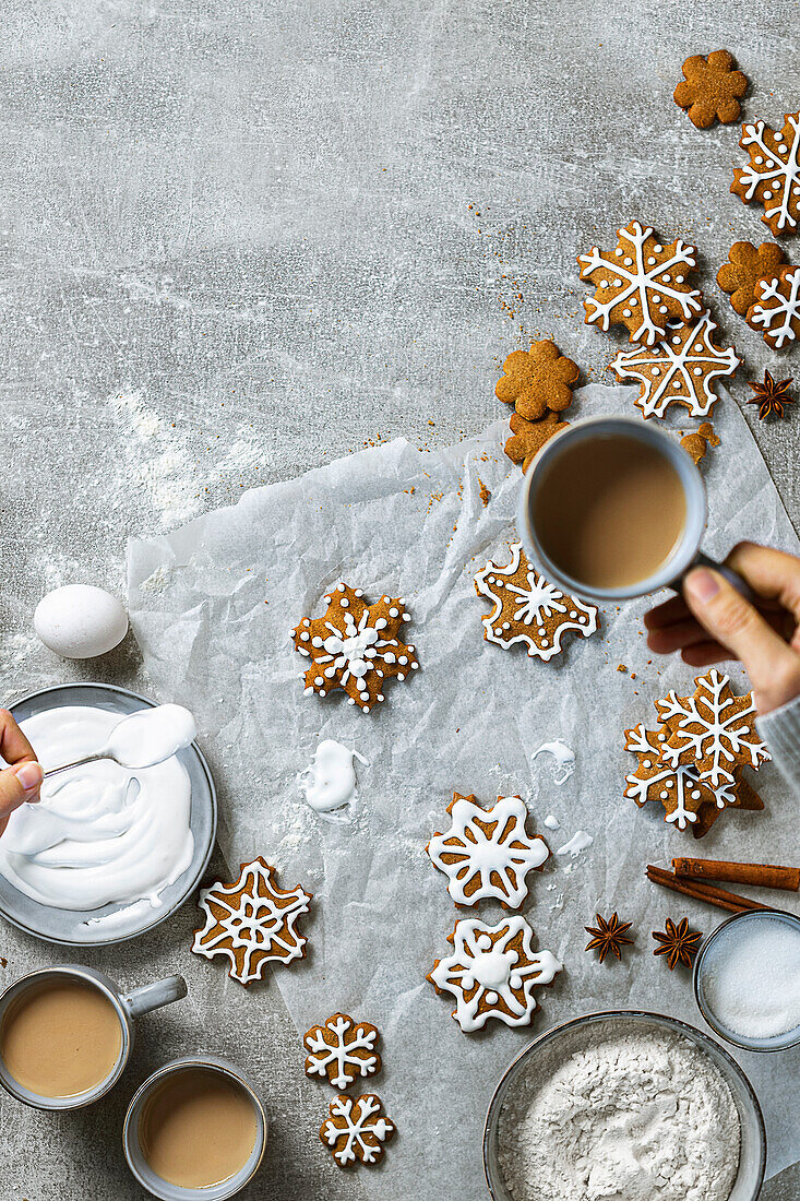 Decorate gingerbread snowflake biscuits with icing
