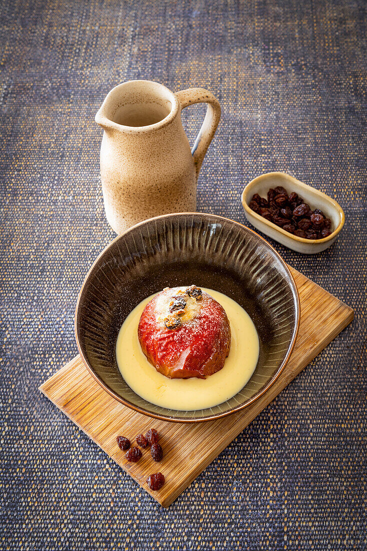 Baked apple with sultanas in vanilla sauce