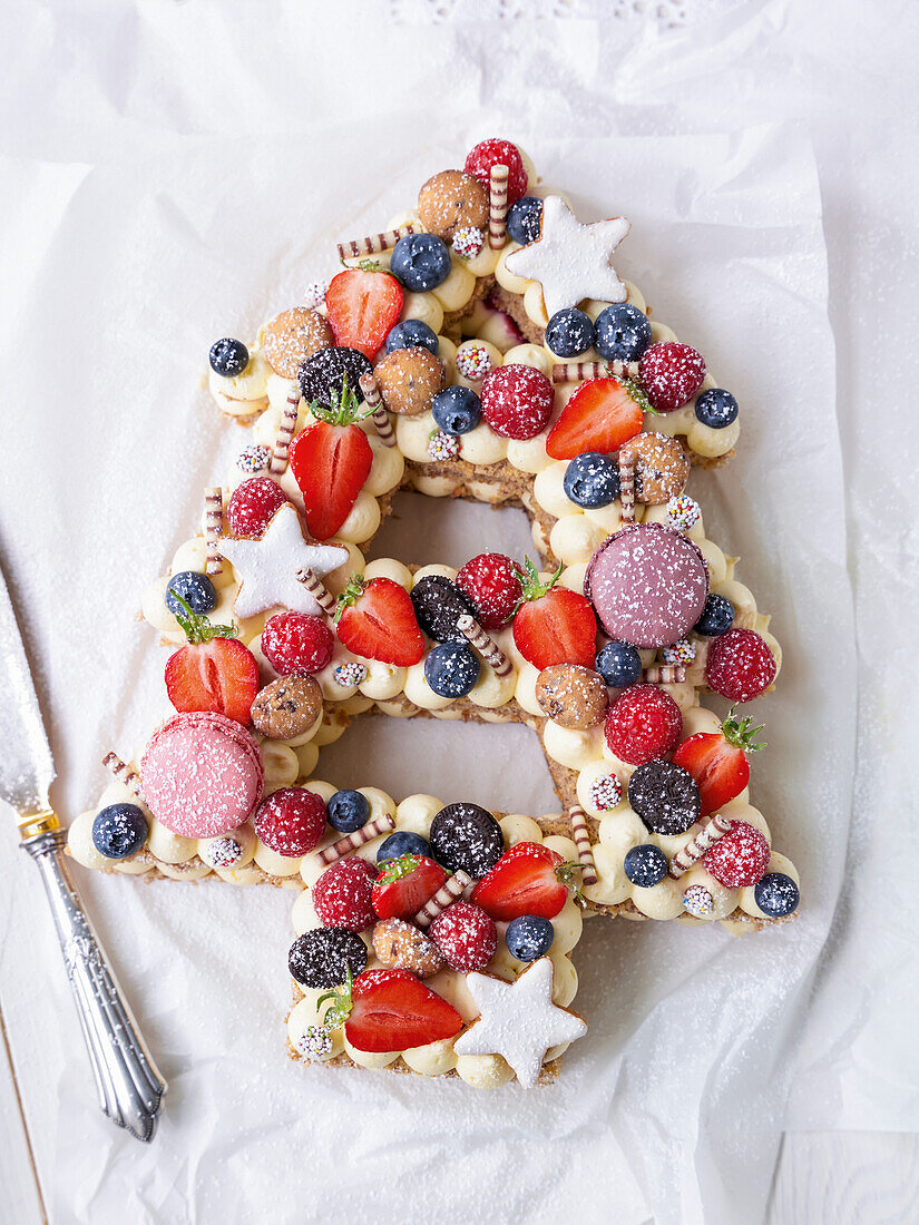 Christmas fir with nuts, macarons and berries