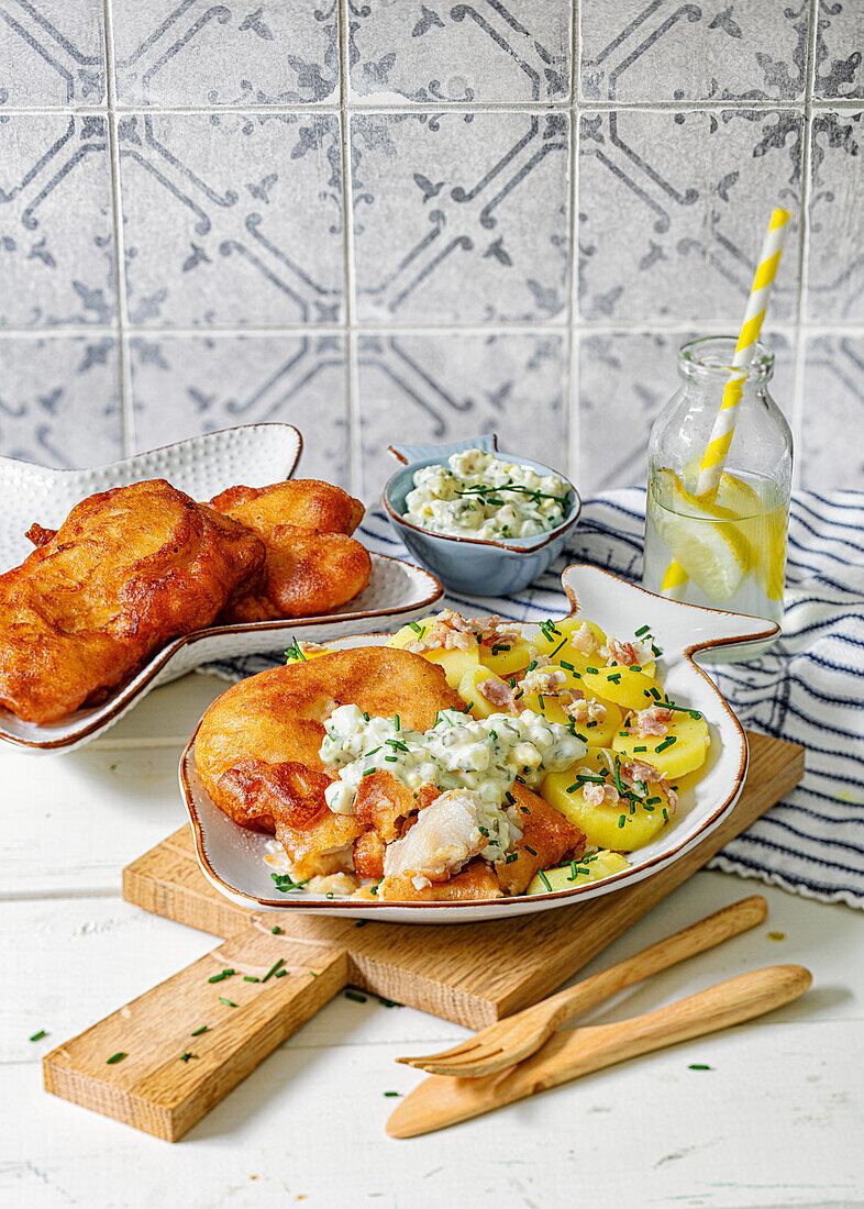 Baked fish menu with potato salad and diced bacon