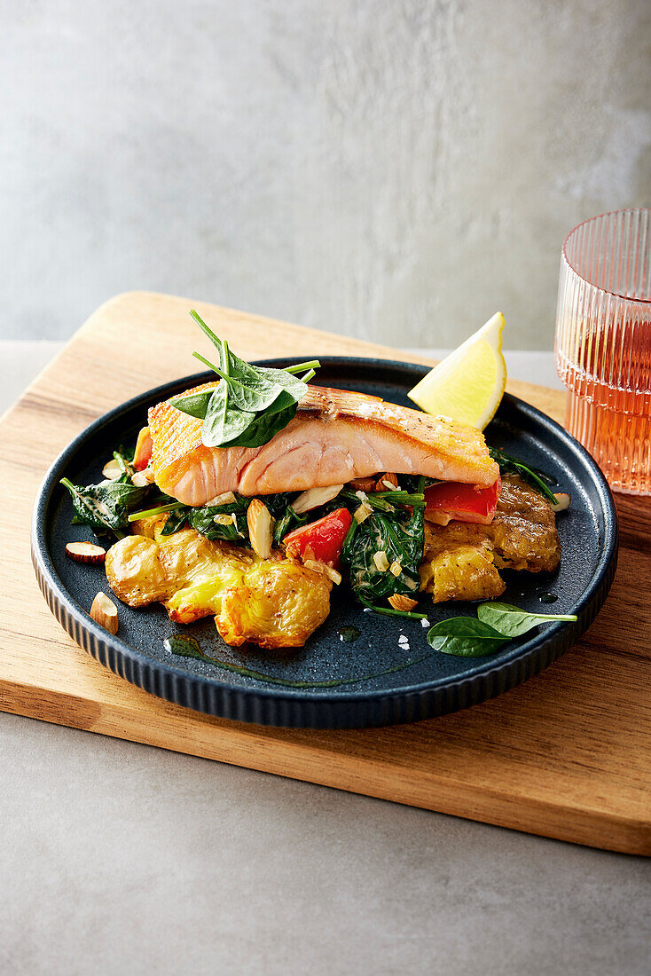 Sous-vide cooked salmon with jacket potatoes and spinach