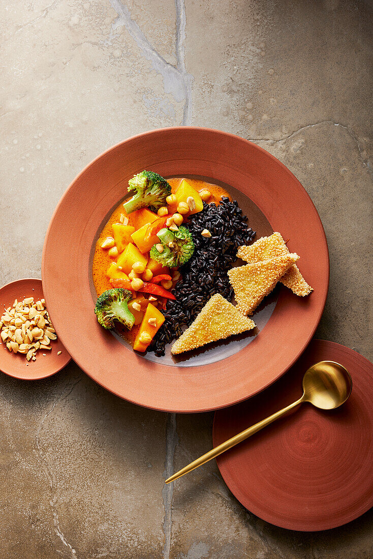 Indian vegetable curry with black rice and honey-sesame paneer