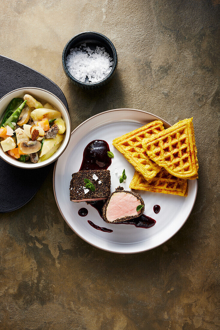 Coffee fillet with vegetable fricassee, plum reduction and potato waffles