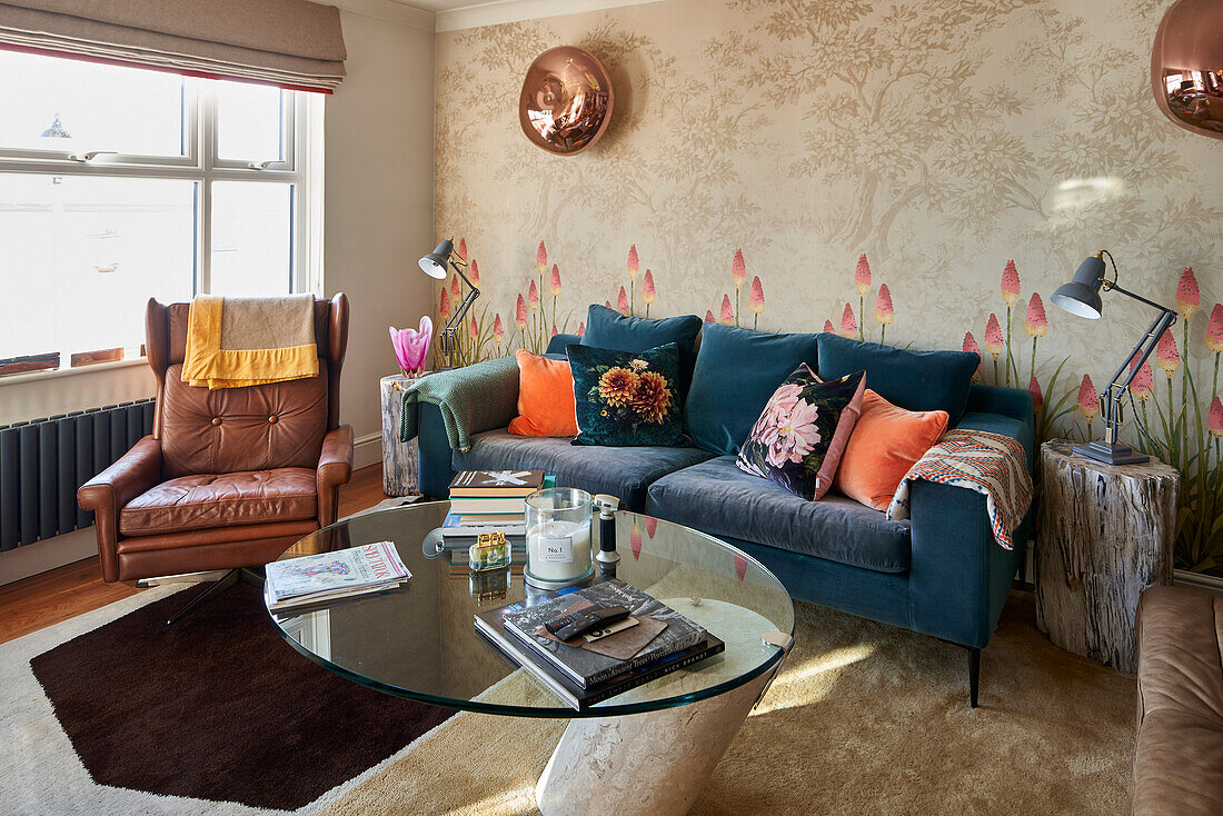 Sitting area with blue upholstered sofa and brown leather armchair in the living room